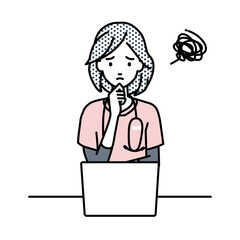 デスクで座ってPCを開いて困っている看護師の女性