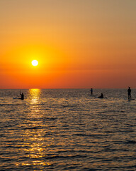 Sunrise on the sea island with servers on the sup.