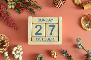 October 27, Cover design with calendar cube, pine cones and dried fruit in the natural concept.