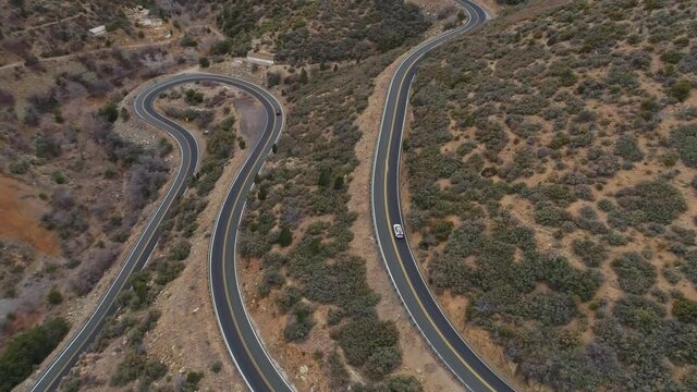 4K tracking aerial following car up winding mountain road Prescott Natl Forest