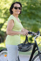 Obraz premium active senior woman ridding bike