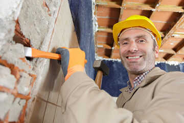 construction worker working with hammer and chisel