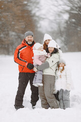Fototapeta na wymiar Big family in winter clothes play in winter park