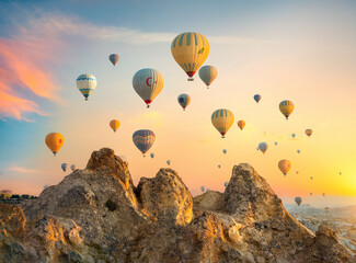 Hot air balloons over rocks