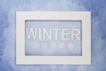 The word, WINTER, spelled in capital letters written horizontally with frame and snowflakes; the word, AUTUMN, placed on a blue painterly background with room for text