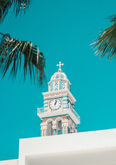mediterranean clock tower in greece with clear sky and palm leafs - obrazy, fototapety, plakaty