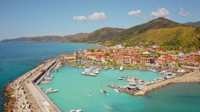 4K aerial - a bird's eye view&nbsp;video (Ultra High Definition). Sunny day on the Mediterraneanm coast of Italy. Captivating summer cityscape of Acciaroli town. Traveling concept background.