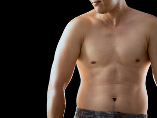 Fototapeta premium Young Asian man shirtless native pant posing relaxing body muscle on black background with copy space