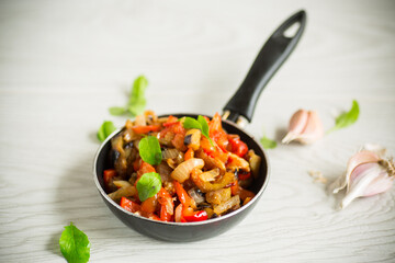 fried eggplants with peppers, tomatoes, onions and garlic