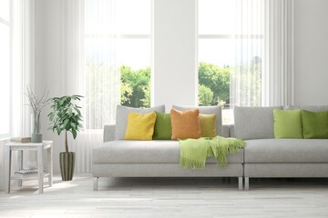 Minimalist living room in white color with sofa and summer landscape in window. Scandinavian interior design. 3D illustration