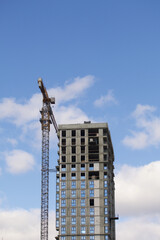 Fototapeta na wymiar Construction of modern multi-storey buildings. Construction of a new city block. Buildings under construction and tower cranes.