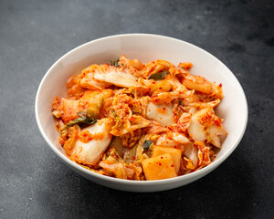 Traditional Korean Kimchi Cabbage in white bowl. Healthy food.
