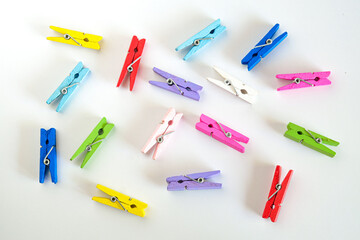 Group of colorful wood clips, cluster isolated on color background.