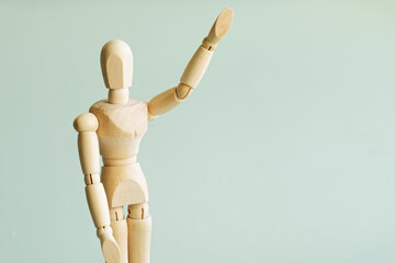 A wooden mannequin raised his hand in greeting, goodbye, or vote. Free space for an inscription