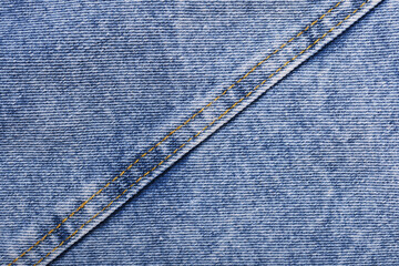 Old blue jeans background and texture close up.Denim seam.