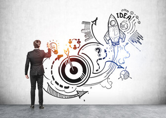 Businessman is touching sketch with icons of rocket launch