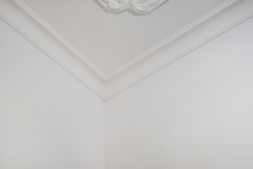 corner of ceiling and walls with intricate crown moulding. Interior construction and renovation...