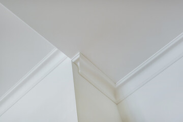 corner of ceiling and walls with intricate crown moulding. Interior construction and renovation...