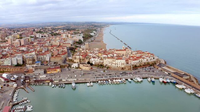 4k drone forward video (Ultra High Definition). Picturesque morning cityscape of Termoli port. Aerial summer seascape of Adriatic sea. Traveling concept background.