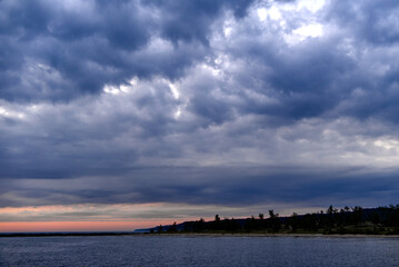 Billowing Clouds over Muskegon Channel shoreline