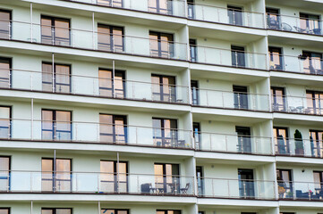 Wall of a modern new building with windows. Beautiful stylish building texture for background