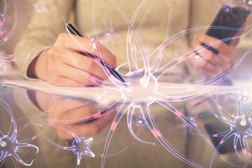 Double exposure of neuron sketch hologram and woman holding and using a mobile device. Education...