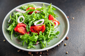 arugula and tomato salad vegetable in a plate fresh portion ready to eat meal snack on the table copy space food background rustic. top view keto or paleo diet veggie vegan or vegetarian food