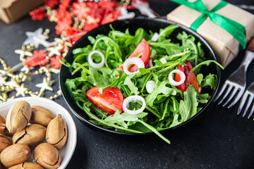 arugula and tomato salad vegetable in a plate fresh portion ready to eat meal snack on the table copy space food background rustic. top view keto or paleo diet veggie vegan or vegetarian food