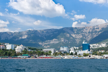 Views of the Crimean coastline with hotels and beaches with mountains in the background.