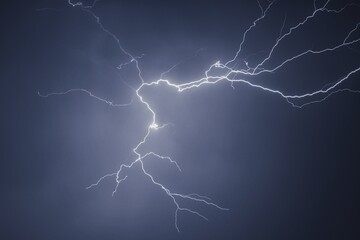 Fototapeta premium Lightning and thunder pictured during a rainstorm in deccan region of india monsoon season