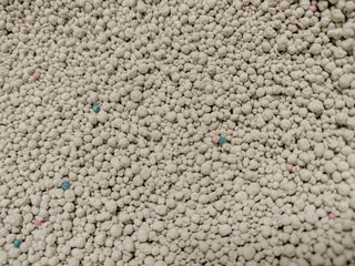 A close up shot of bentonite white colored pet litter sand  