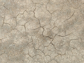 A close up shot of droughty sand mud during harsh summers with cracks in the soil 