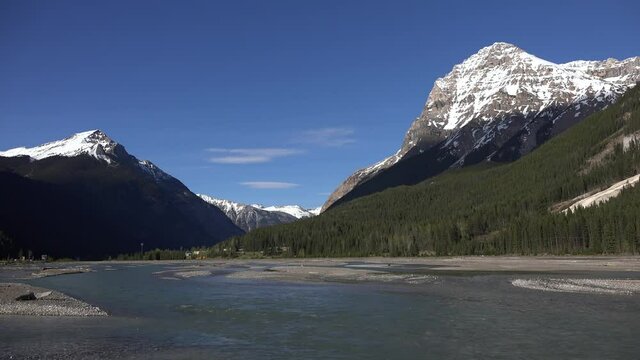 the rocky mountains with a river on a spring day