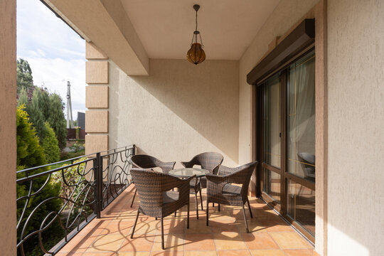 Summer terrace of a private house with chairs and a table for outdoor dining. Recreation.