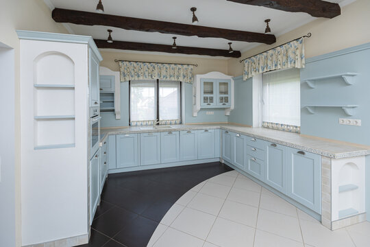 Kitchen, dining room of a private house, decorated in light blue colors in the Provence style.