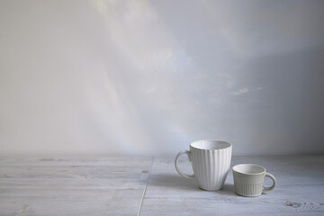 Minimalistic Scandinavian style. Two cups of coffee or tea of different sizes for two on on the table.
