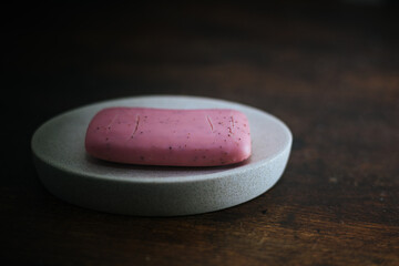 closeup photo of a dry pink bar of soap on a soap dish - 459322846