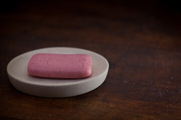 closeup photo of a dry pink bar of soap on a soap dish - 459322854