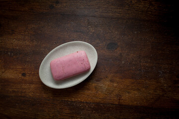 closeup photo of a dry pink bar of soap on a soap dish - 459322888