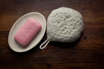 closeup photo of a pink bar of soap and a bath sponge - 459322899