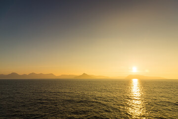 Sea landscape, vivid sunset. Cliffs on the horizon.