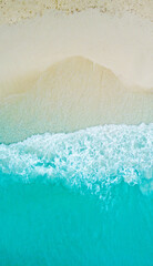 Top view of the beautiful ocean shore with waves and foam on the sand. Seychelles. Texture and...