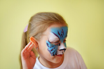Girl aqua makeup in the form of a blue water tiger zodiac on a white background, concept symbol of the new year 2022, overhears a portrait. High quality photo