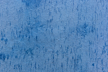 background of a blue painted cement wall with some raindrops