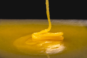 Fresh viscous floral honey flows onto the plate. vitamin organic food