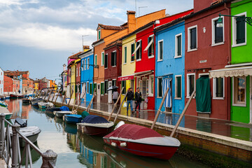 Fototapeta na wymiar Spring, daytime ,Italy, Burano, colourful houses, boats, canal, water reflection