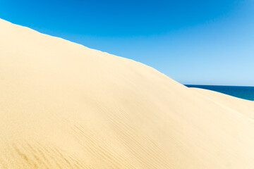 Blue sky and sand dunes in sunny day.