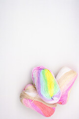 Yarn. Yarn for knitting. The colors of the rainbow. Woolen threads. Knitting needles for knitting in balls of thread.