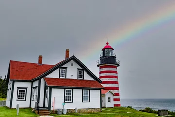  Landscape image of the West Quoddy Head Lighthouse under a rainbow in Lubec, Maine. © TD
