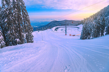 Ski slopes with cable cars at sunrise, Poiana Brasov, Romania